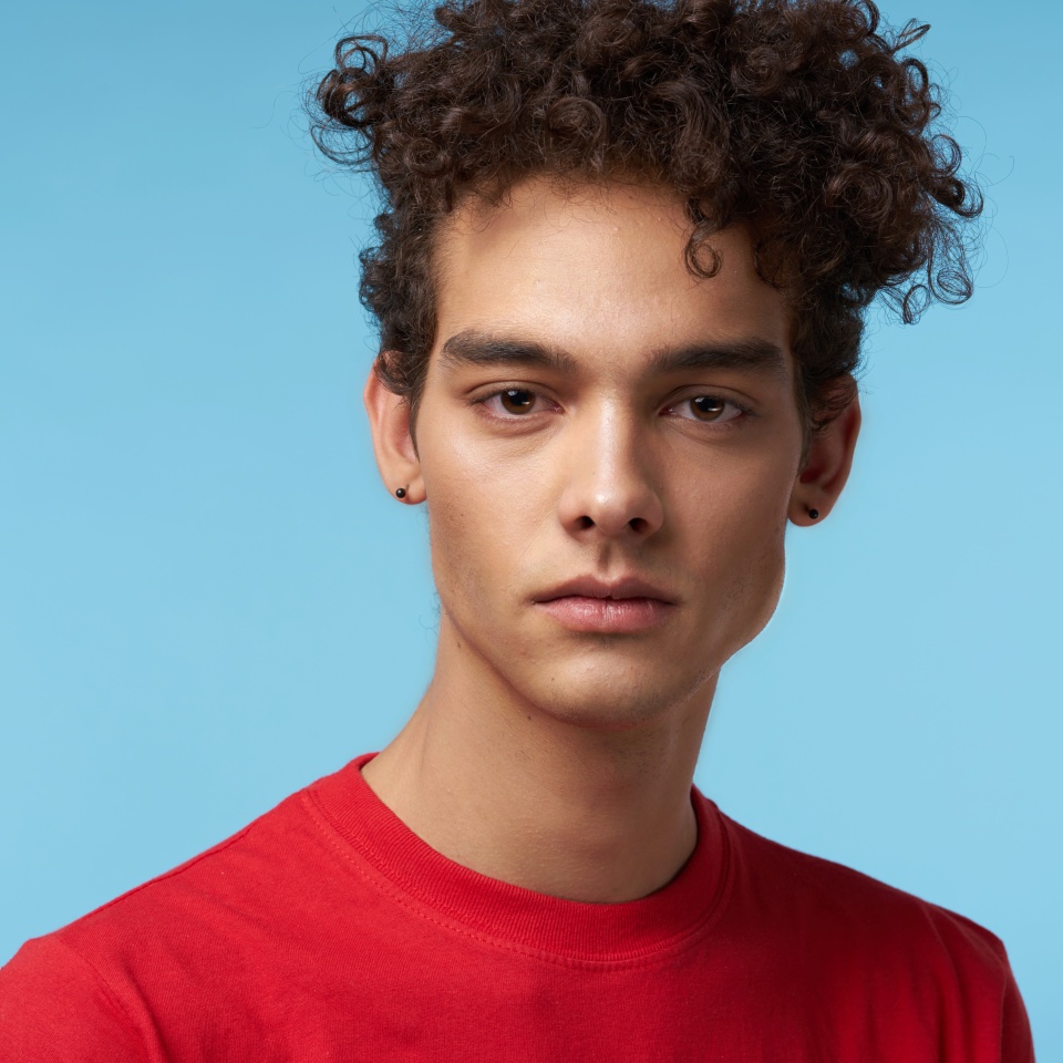 Cute man in red t-shirt over blue background
