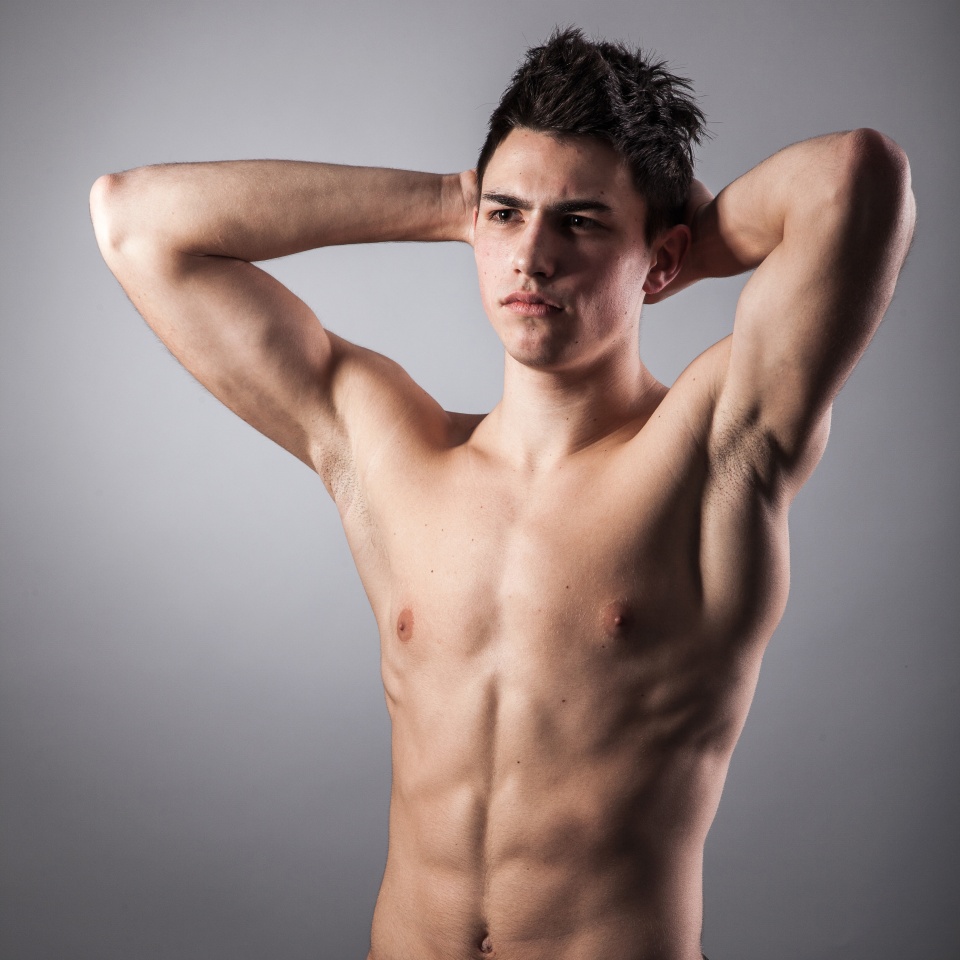 Portrait of young bodybuilder man on a black background