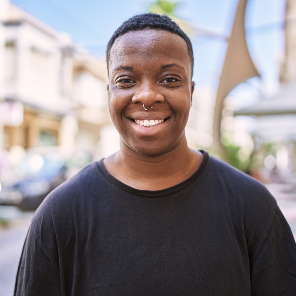 Young african american transgender smiling confident at street