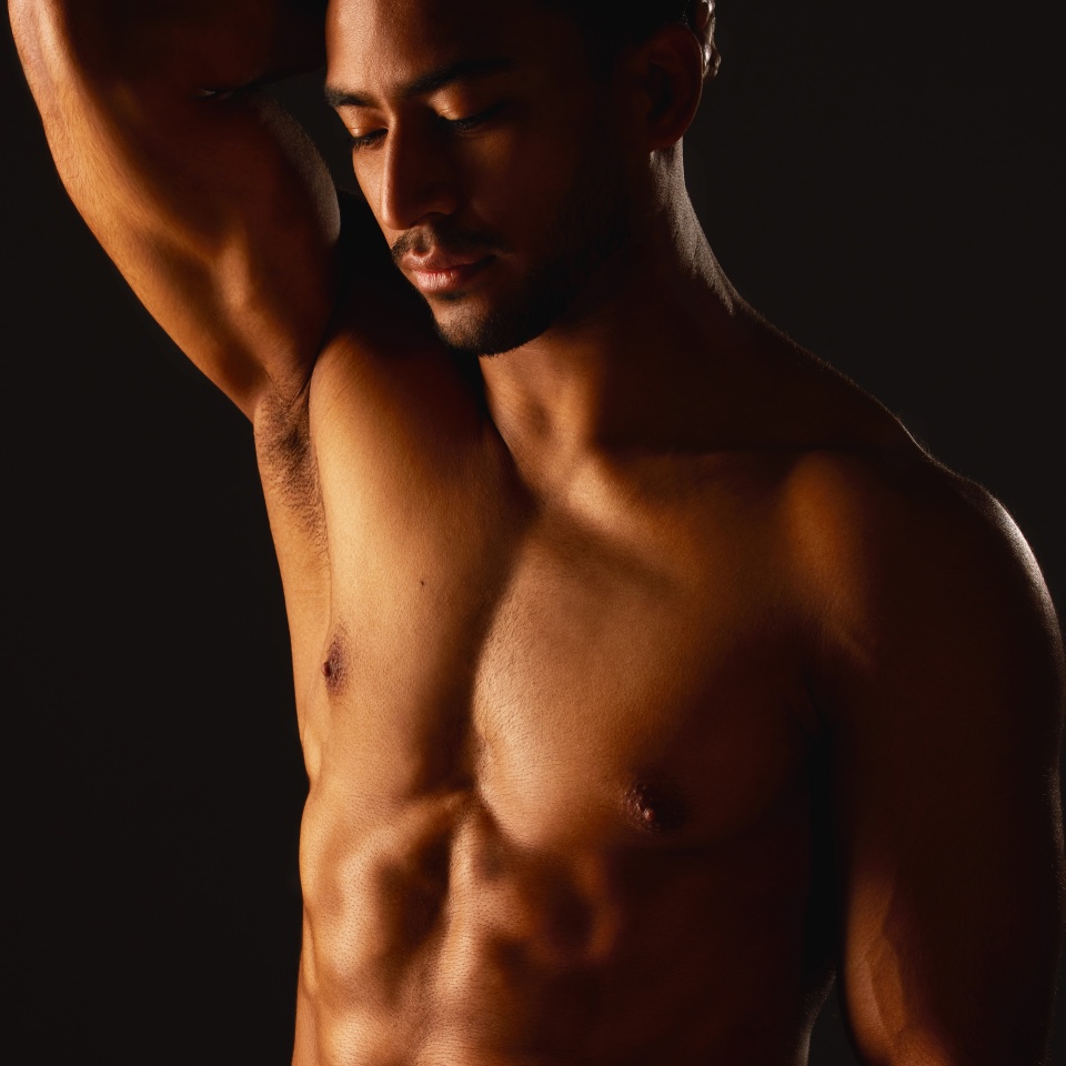 Stand back and watch me grow. Studio shot of a fit young man posing against a black background.