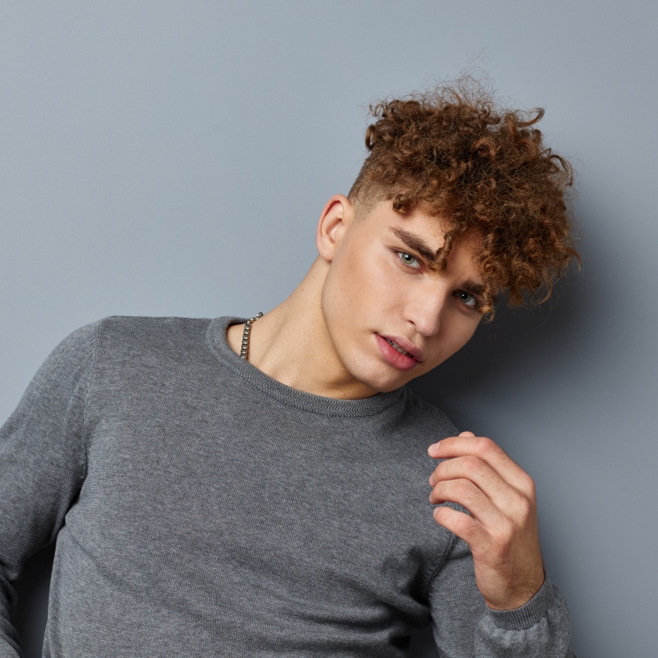 handsome young man sexy posing self confidence isolated background