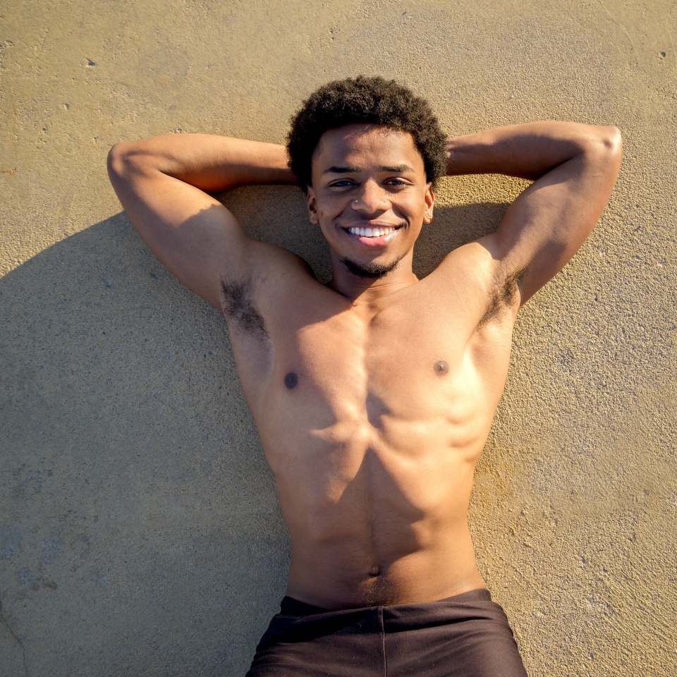 Cheerful young guy. Happy guy smiling looking at camera. Latin guy portrait. 18-20 years old.