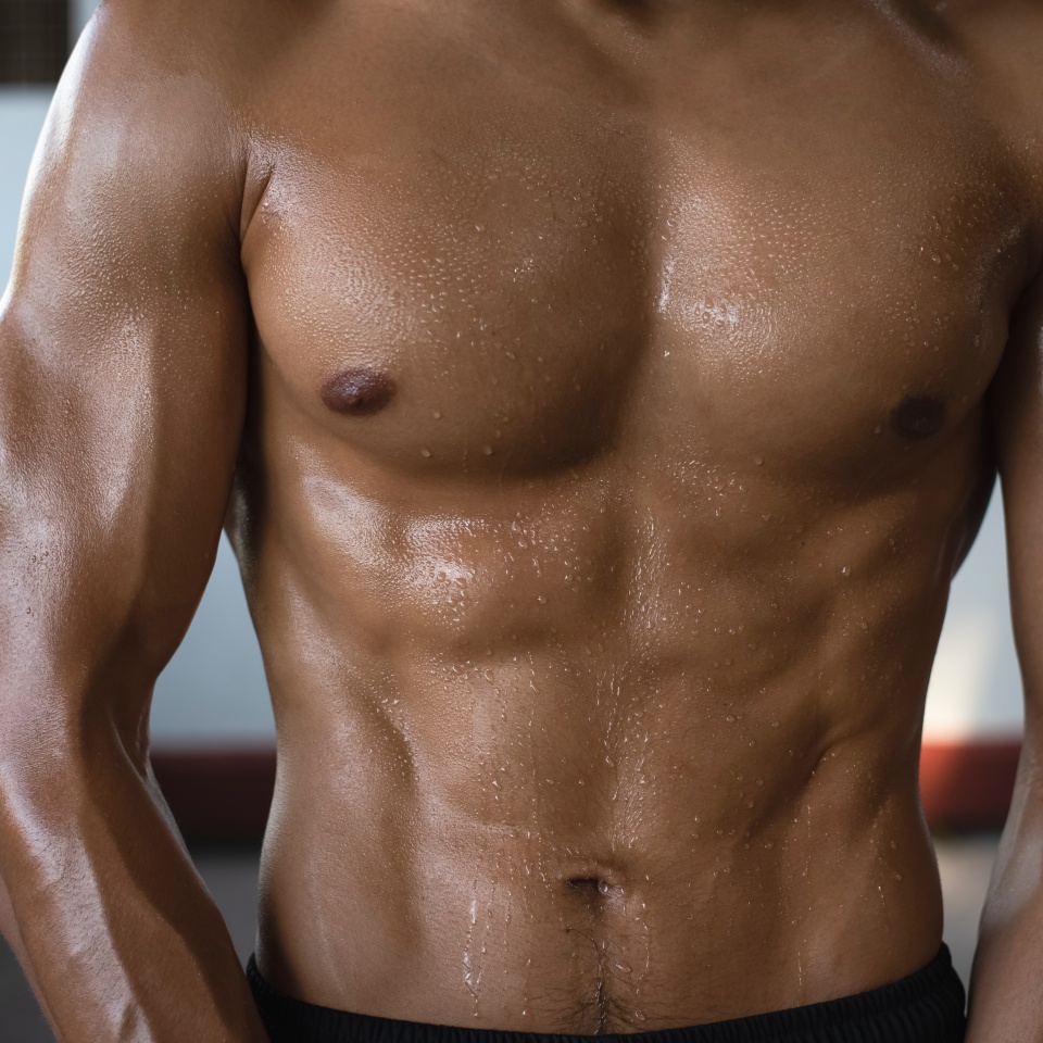 Fit and firm muscle of young man from exercise,drenched in sweat,wet all over body,blurry light around,