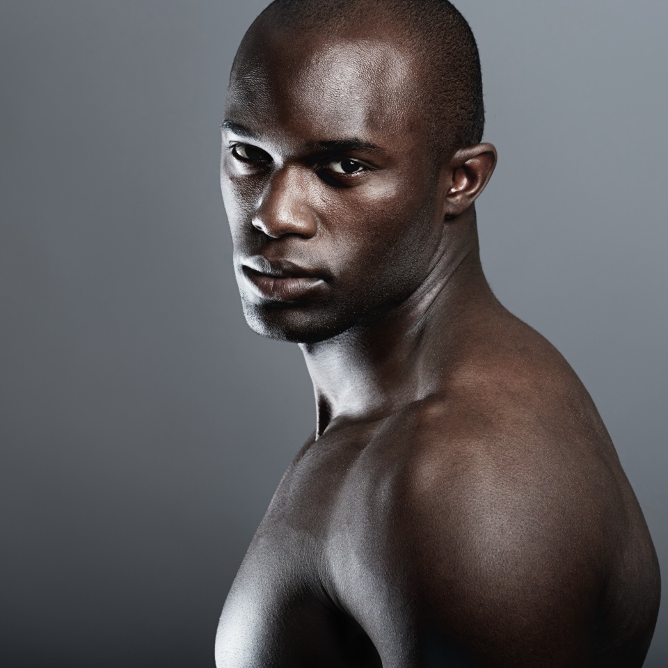 Art, beauty and portrait of black man on dark background with muscle and mockup, serious body builder in Africa. Health, wellness and mock up space, African male model isolated on studio backdrop.