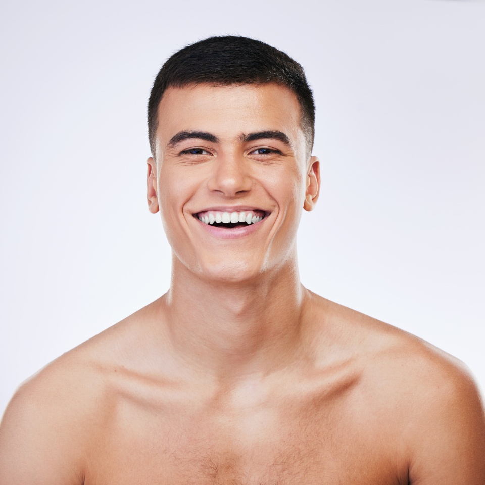 Man, beauty and face, skin and happy with grooming for hygiene and clean isolated on white background. Portrait, model and dermatology, skincare and treatment with cosmetics and wellness in a studio