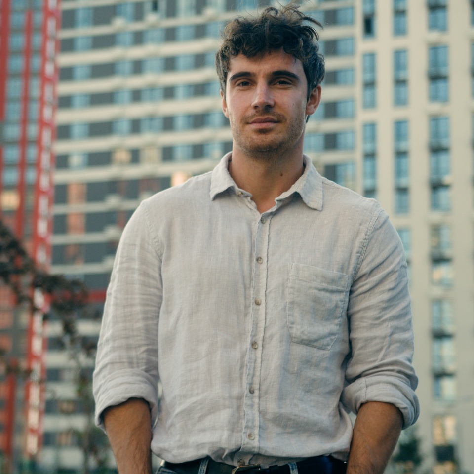 Caucasian man millennial thoughtful male looking away outdoors confident calm guy businessman look camera smile confidence handsome model boyfriend tourist on modern urban buildings background in city