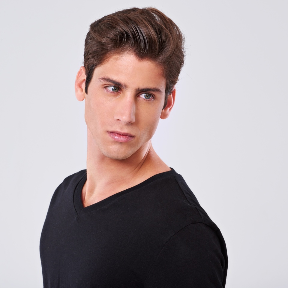 Handsome man, grooming and style with hair, fashion or tshirt on a gray studio background. Attractive male person, caucasian or model with trendy hairstyle, clothing or barber treatment on mockup
