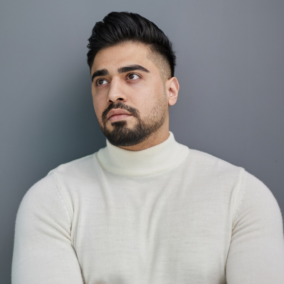 Portrait of stylish middle aged man posing on gray background