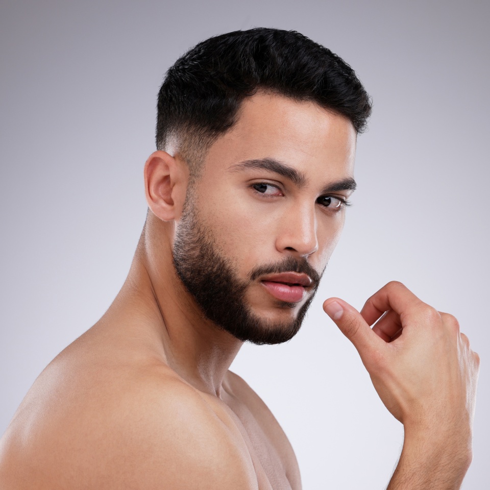 Thinking, skincare and natural beauty of man in studio for grooming isolated on white background. Dermatology, serious face and model in cosmetics for health, wellness and clean facial aesthetic