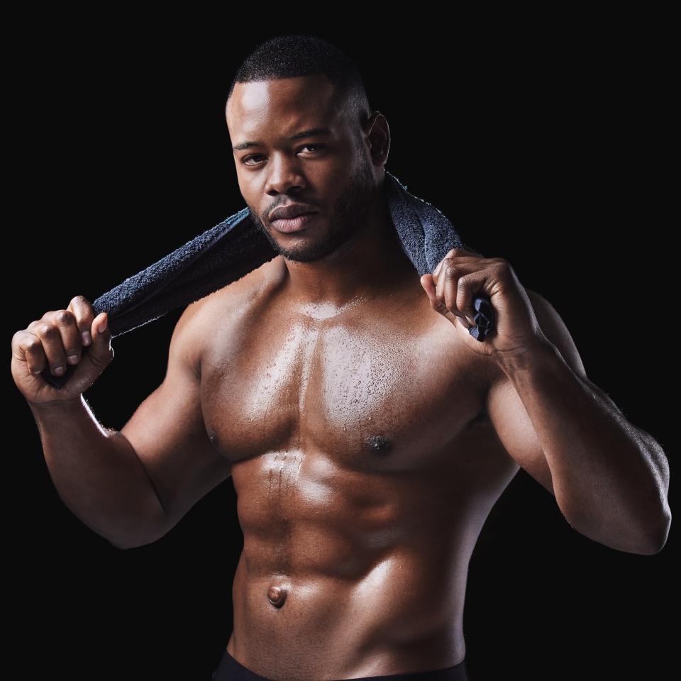 Portrait, body and black man with neck towel for sweat, sports training and workout goals in studio. African male person, bodybuilder and exercise for muscle results and health by dark background