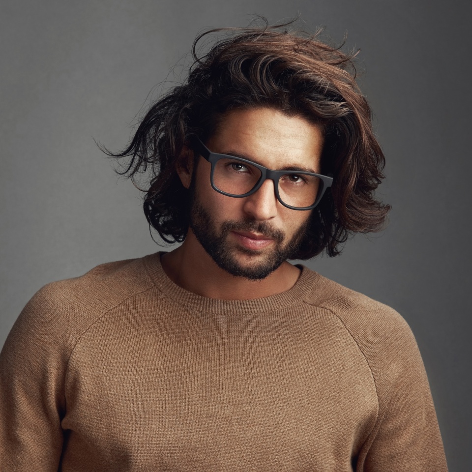 Designer, modern or portrait of man with glasses, vision or clear sight on grey background in studio. Prescription eyewear, face and confident male mode with fashion, health or cool spectacle frame