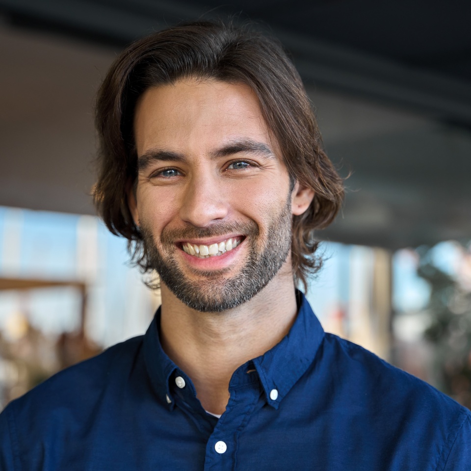 Happy young European professional business man, casual guy looking at camera, headshot close up face portrait. Confident smiling businessman, male entrepreneur, small business owner posing outdoors.