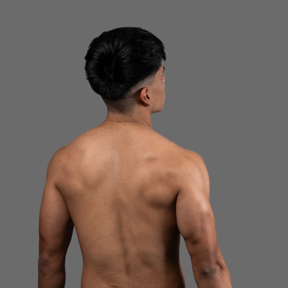 Shirtless hispanic fitness model showing his back muscles while turning his head