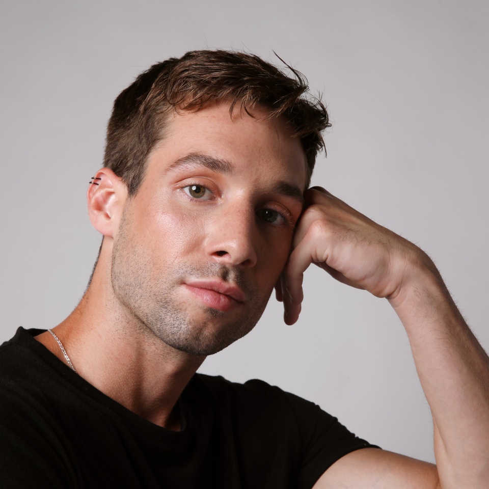 Portrait of young man wearing casual clothing posing over white background. Mental health.
