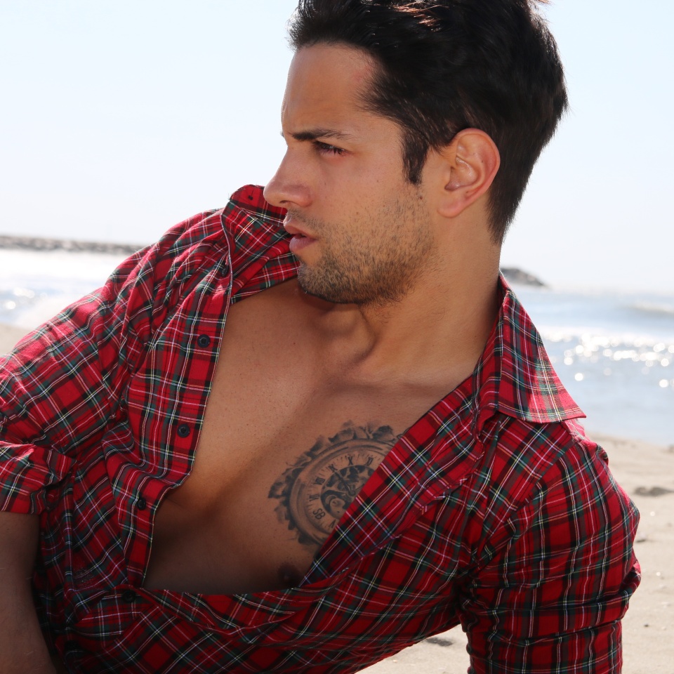 handsome man lying on the sand
