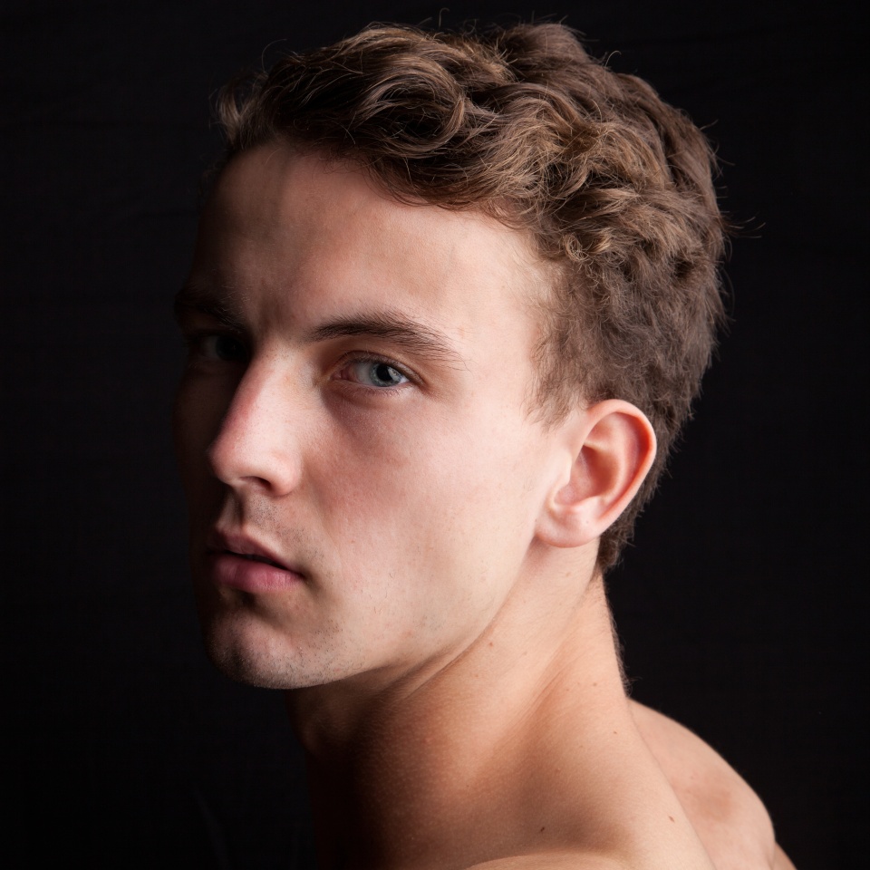 Portrait of an attractive man in front of a black background