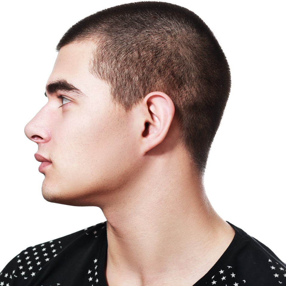Side view of a handsome young man facial portrait isolated on a white background