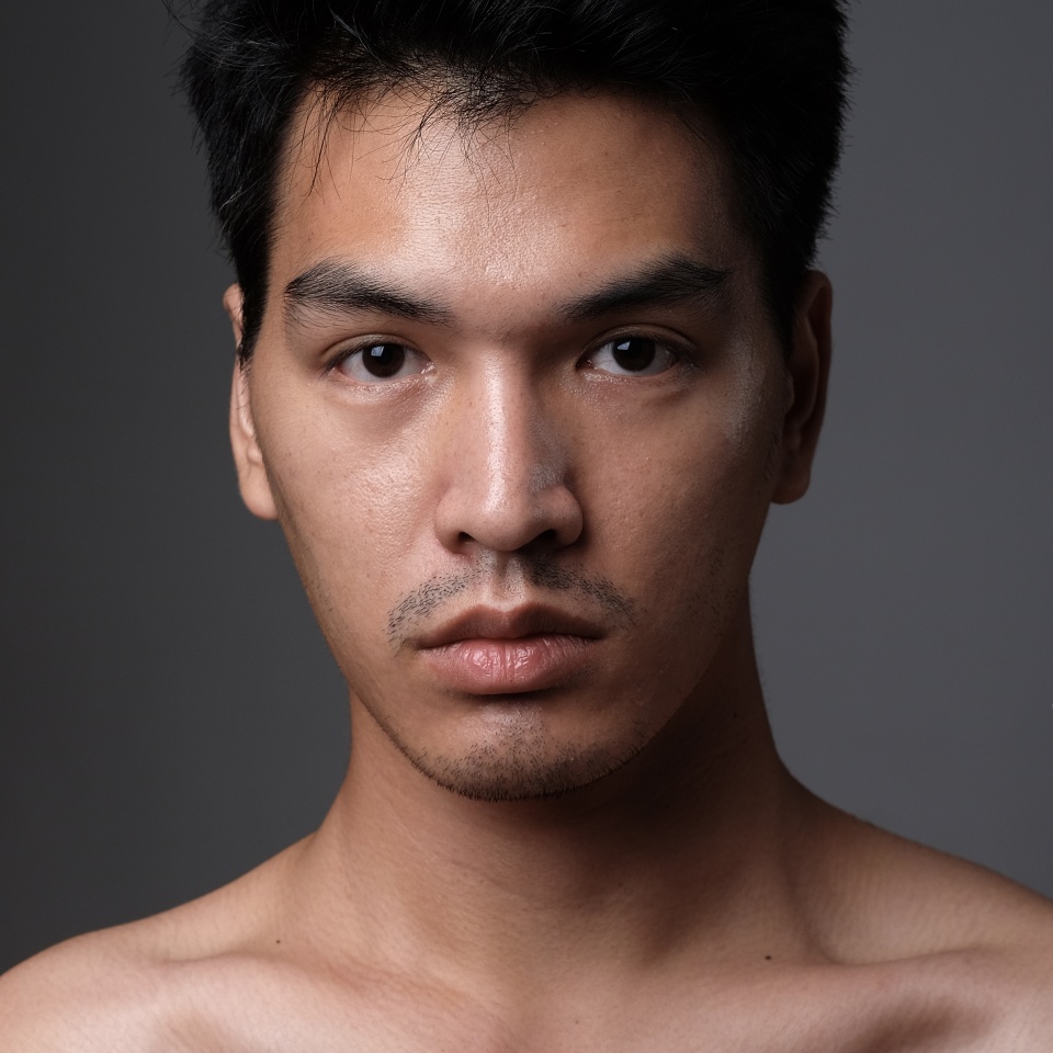 Asian man portrait with no makeup show his real skin in grey background - soft focus
