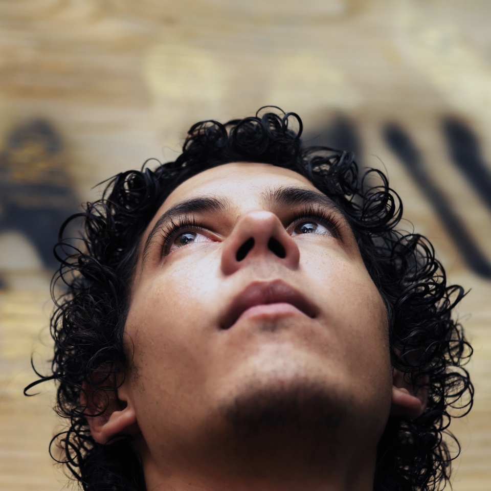 Portrait of young hispanic teen boy against grunge background