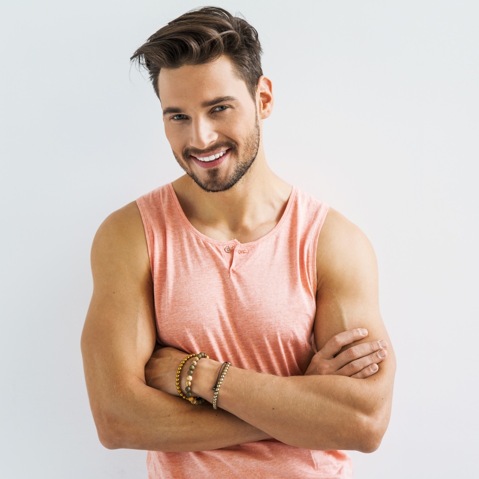 Sexy smiling male model with crossed arms