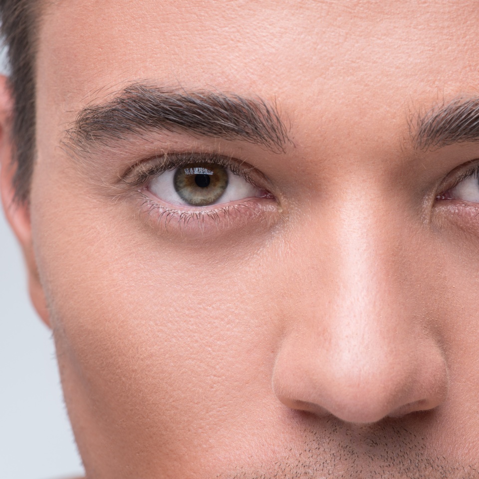 Charming guy is watching pensively